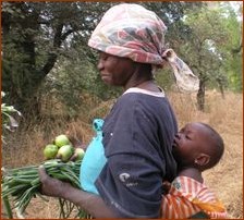 Avec son enfant au dos, jeune femme burkinabè, mains chargées de courges
